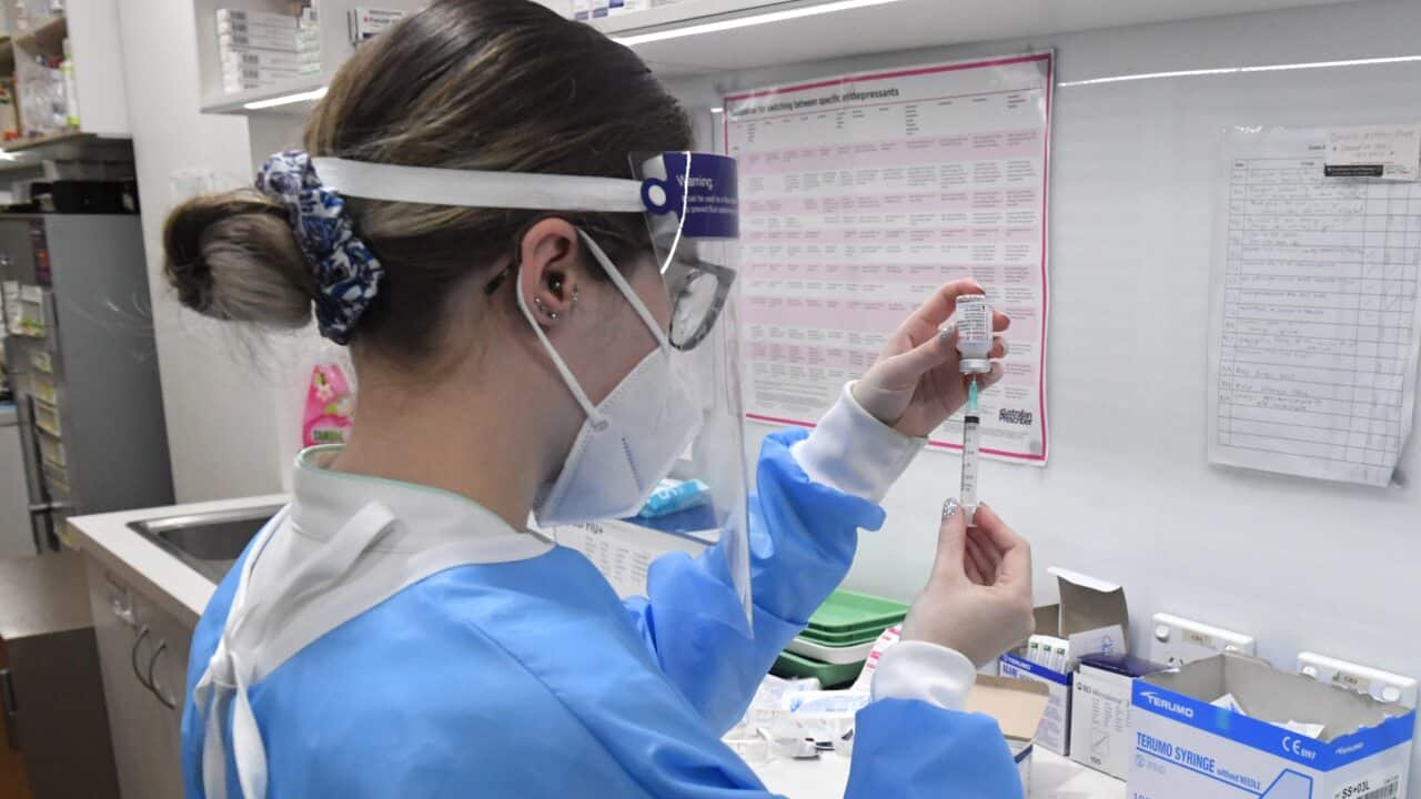 A pharmacist loads up injections of the Moderna COVID-19 vaccine at Cooleman Court Pharmacy in Canberra