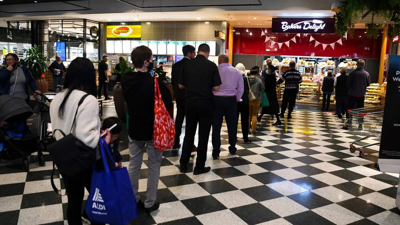 Customers queue at a bakery in Woden, Canberra following the lockdown announcement