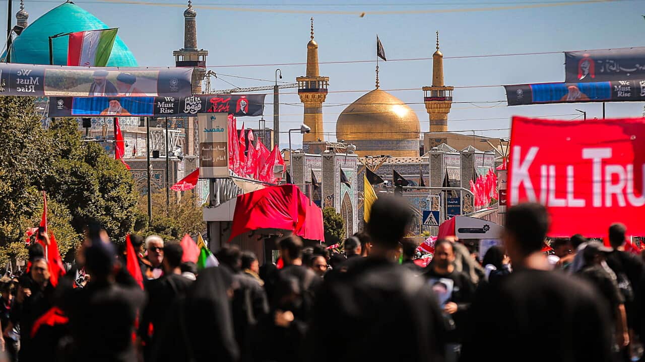 Crowds marching with banners.