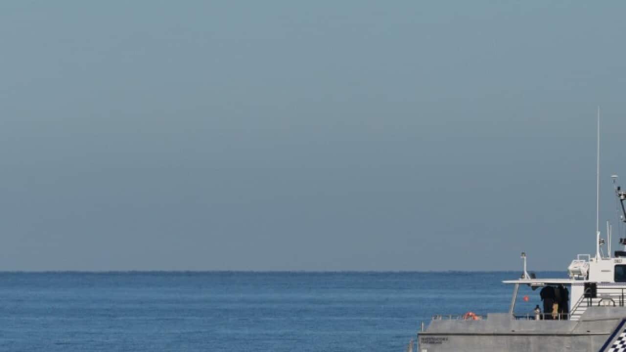 Police divers search for a missing teenage girl off Glenelg Beach in Adelaide, Monday, December 11, 2017.