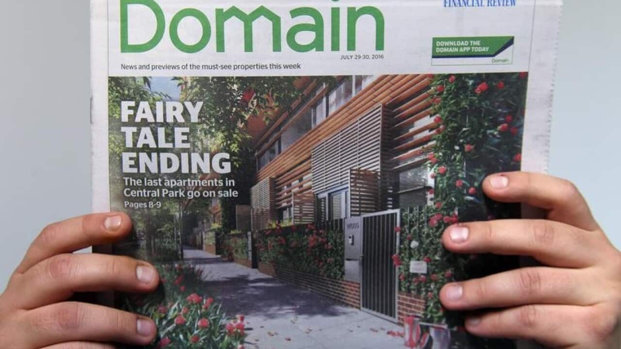 Image of Domain front page held up by pair of hands