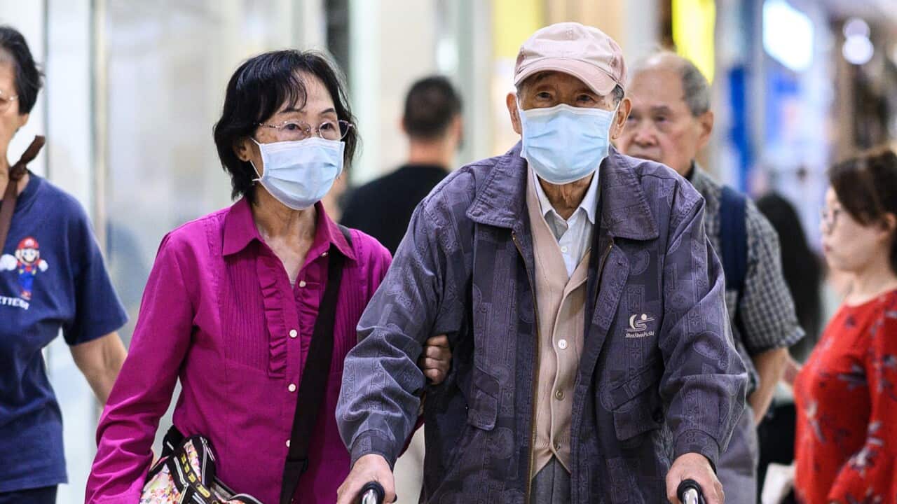 A couple wearing face masks in Sydney