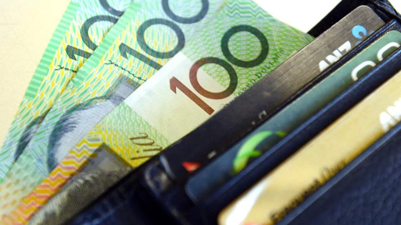 $100 notes pop out of a wallet