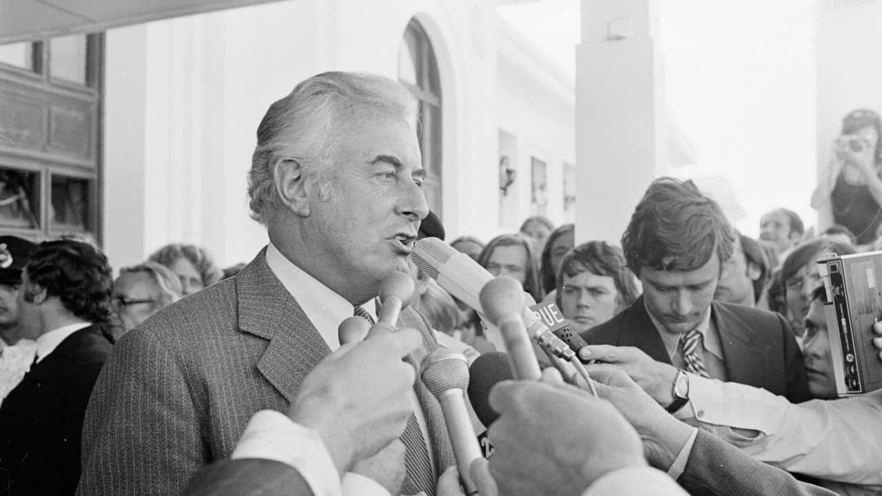 Gough Whitlam speaks into microphones while standing in a crowd of people on the steps of Parliament House in Canberra following his government's dismissal on November 11, 1975.