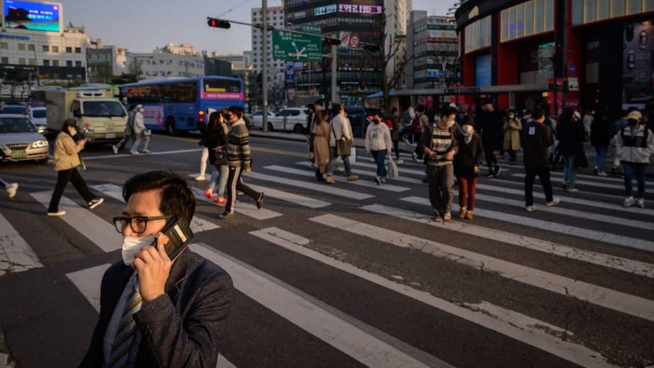 People wearing face masks amid precautions against the COVID-19 coronavirus in Seoul.