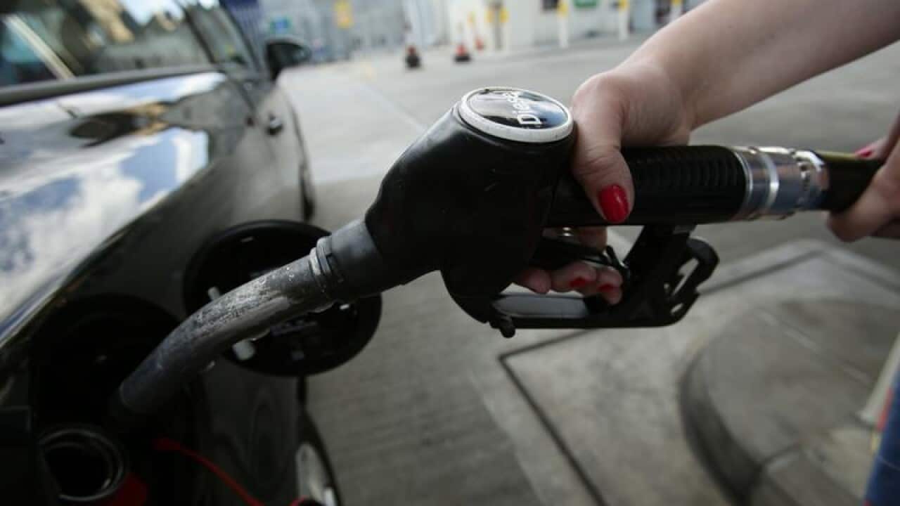 car being filled up with a pump at a petrol station