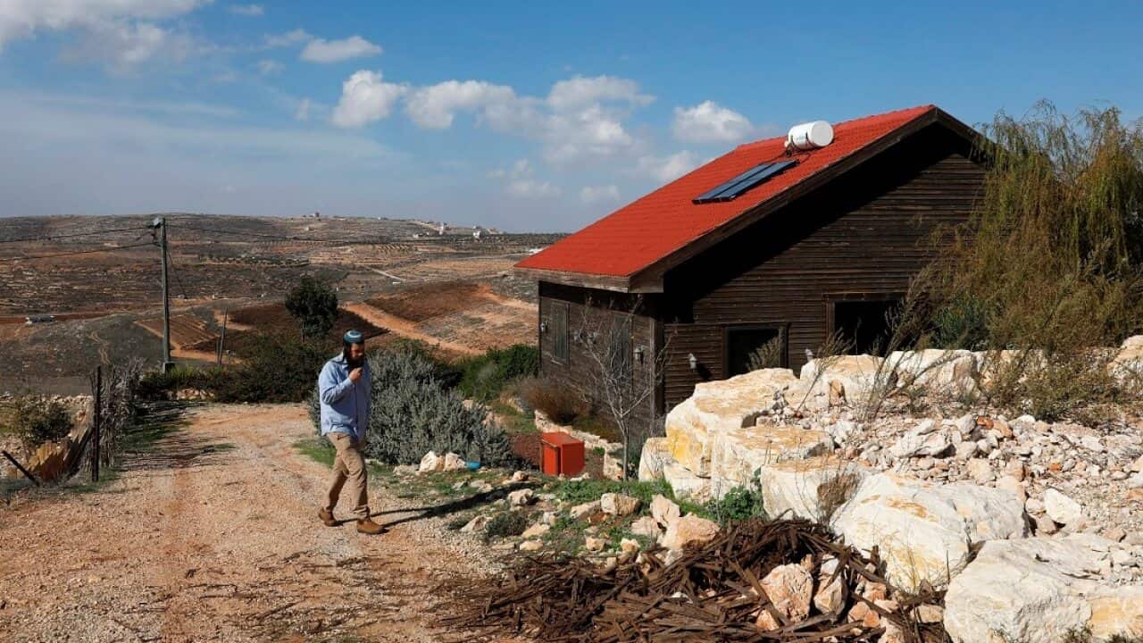 Nati Rom, who is campaigning against the Palestnian-led boycott movement, walks next to an Airbnb apartment located in the occupied West Bank.