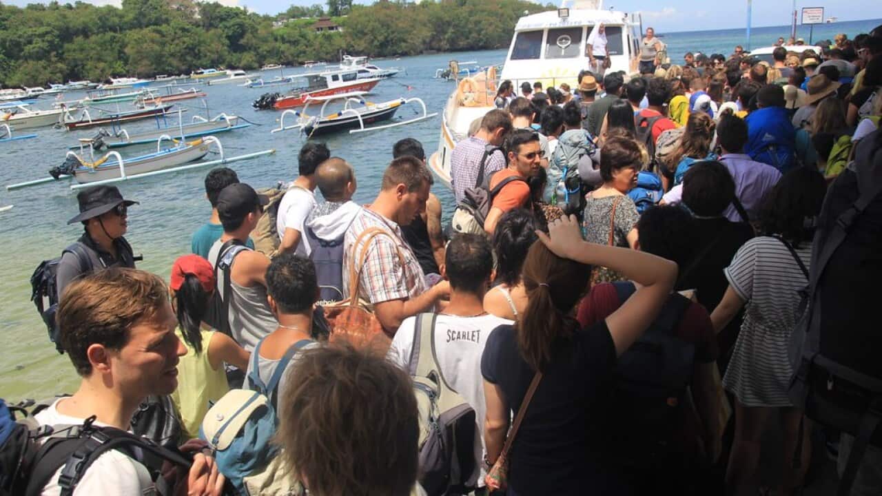 Forming a queue to get on the ferry.