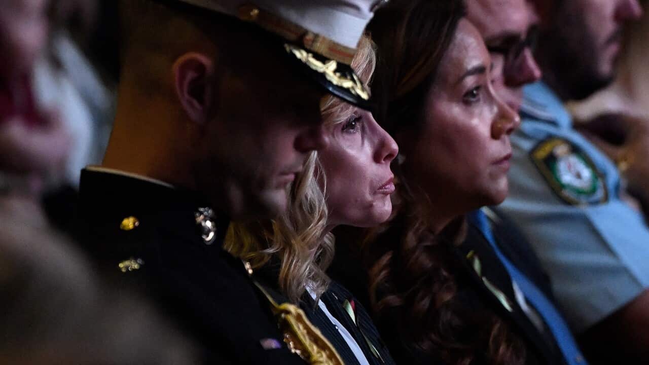 Widow Noreen Hudson (centre), wife of deceased Coulson Aviation US firefighter Paul Hudson, is seen during a Bushfire State Memorial at Qudos Bank Arena in Sydney, Sunday, February 23, 2020. (AAP Image/Bianca De Marchi) NO ARCHIVING