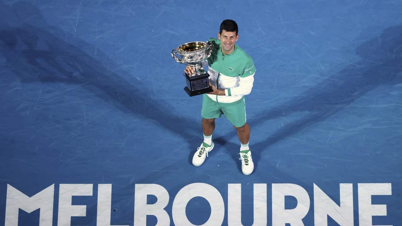 Serbia's Novak Djokovic holds the Norman Brookes Challenge Cup after winning the men's singles final at the Australian Open in Melbourne, 21 February, 2021.