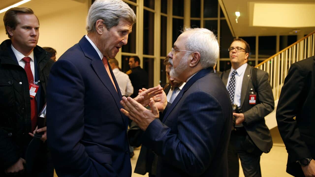 U.S. Secretary of State John Kerry talks with Iranian Foreign Minister Mohammad Javad Zarif, right, after the International Atomic Energy Agency (IAEA) verified that Iran has met all conditions under the nuclear deal, in Vienna, Saturday Jan. 16, 2016. (
