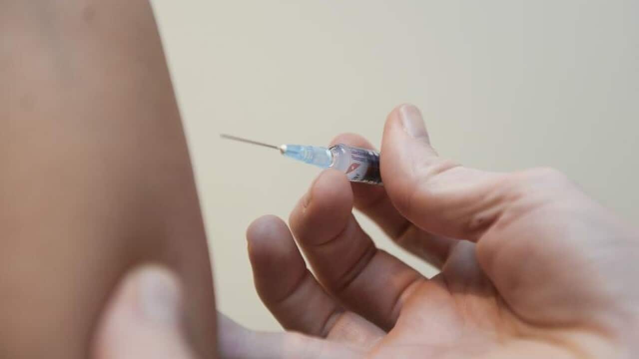 A doctor injects medication