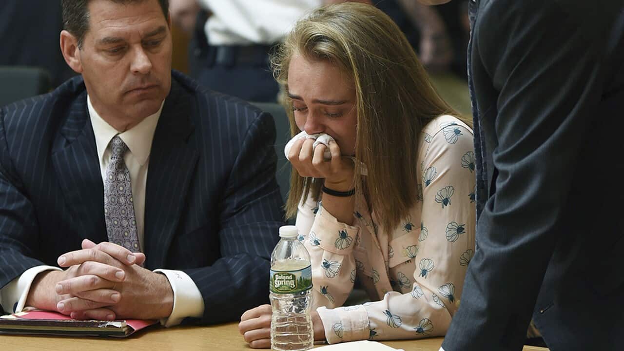Michelle Carter cries while flanked by defense attorneys Joseph Cataldo, left, and Cory Madera, after being found guilty of involuntary manslaughter in the suicide of Conrad Roy III