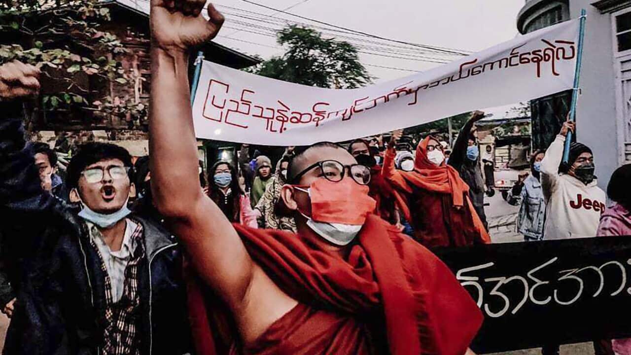 A Buddhist monk raises his clenched fist while marching during an anti-military government protest rally on 1 February, 2022, in Mandalay, Myanmar.