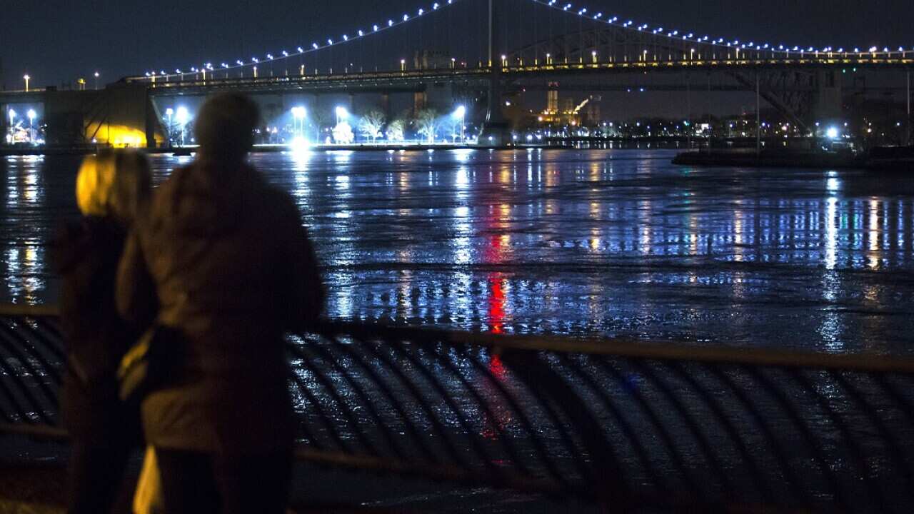 People look at New York City's East River after a helicopter crashed into the water in New York City, New York, USA, 11 March 2018.
