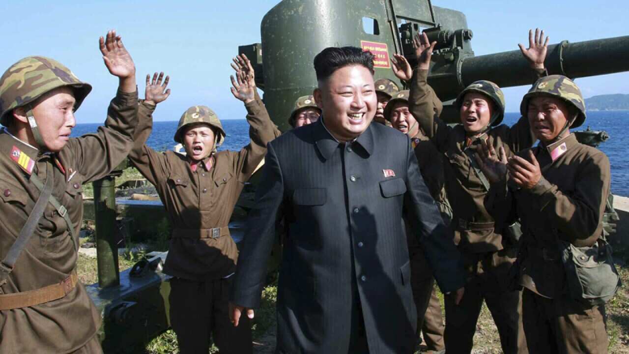 North Korean leader Kim Jong-un (C) surrounded by cheering soldiers