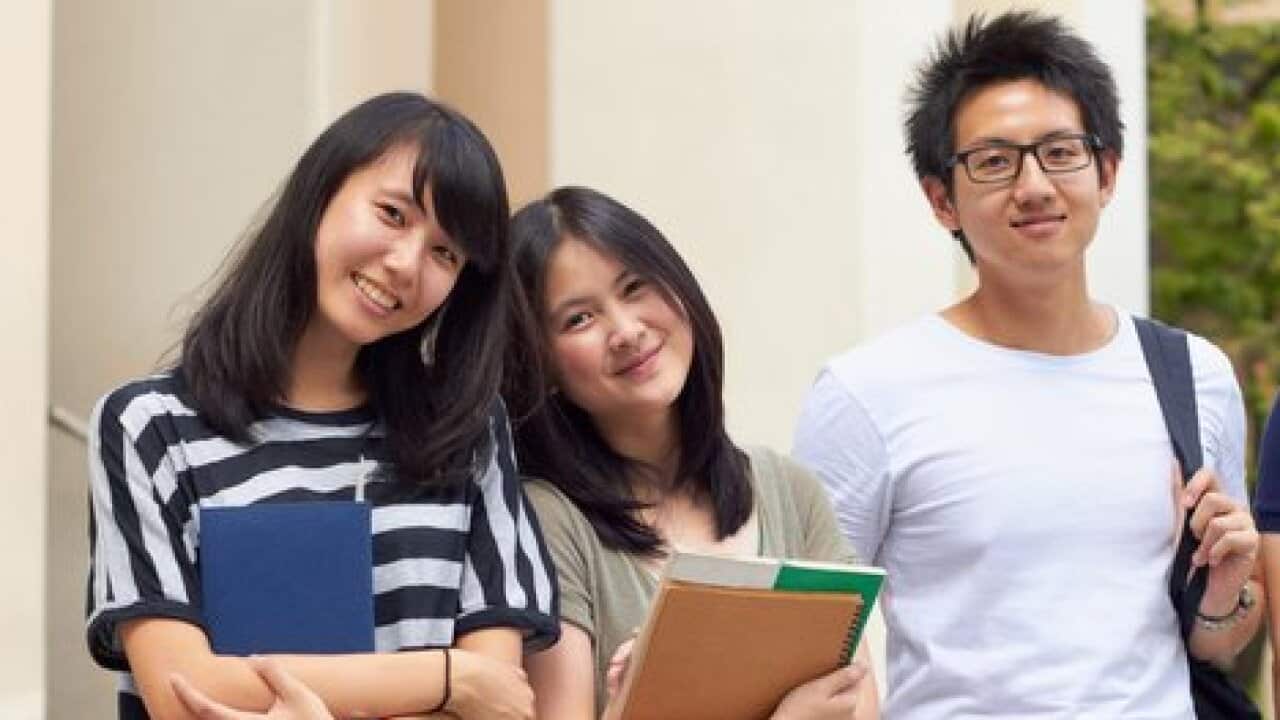 Four young students leaving campus