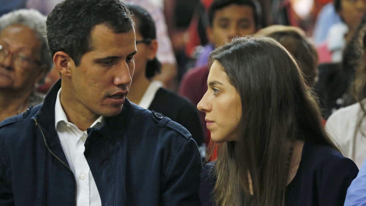 Opposition National Assembly leader Juan Guaido, who declared himself interim president, sits with his wife Fabiana Rosales.