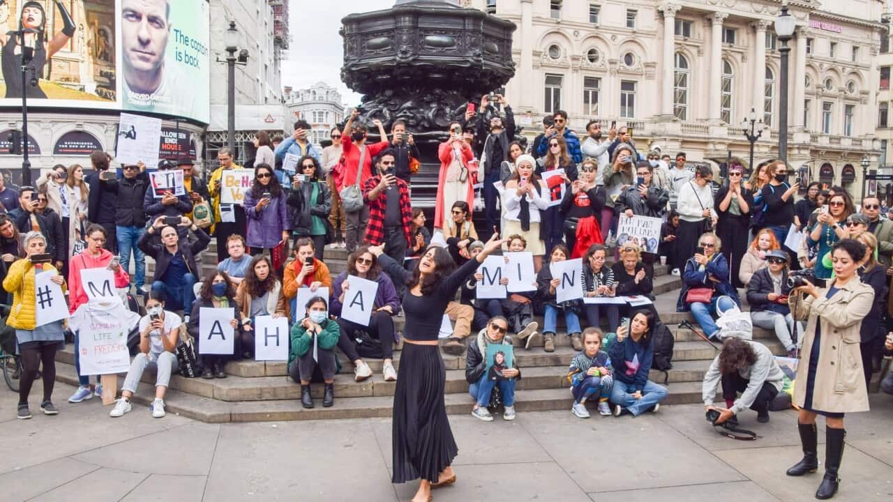 A woman dances to a reworked version of protest anthem "Bella Ciao" during a rally in London.