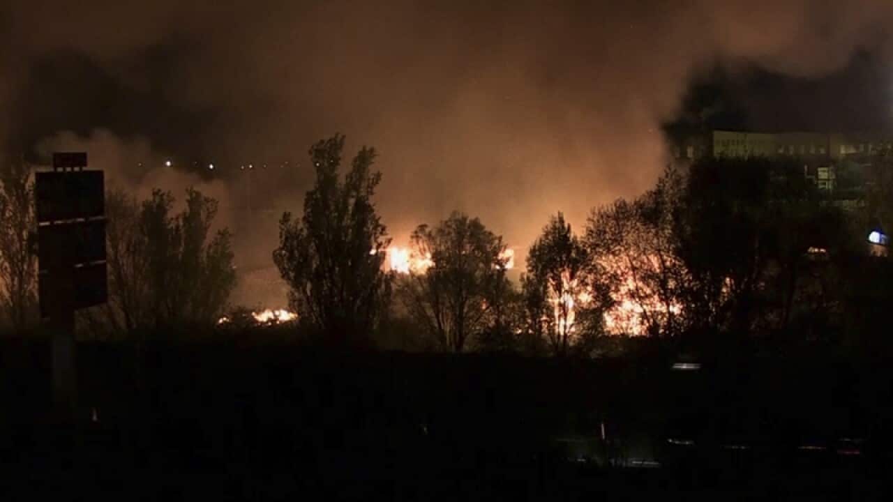 Blaze and smoke rise from a migrant camp near Dunkirk in France