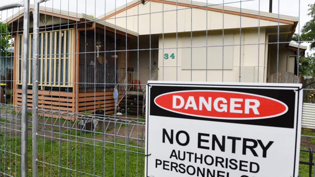 A fence surrounds a house in which eight children were murdered