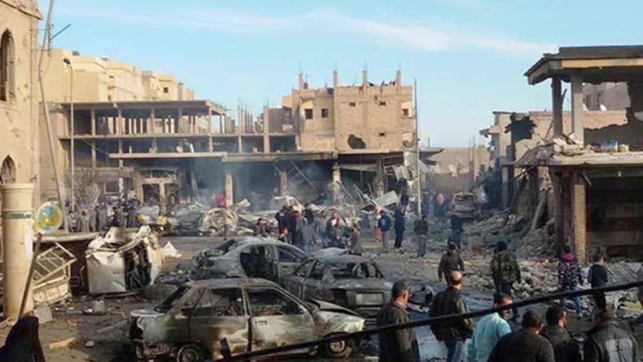 Damaged buildings following an airstrike in Raqa