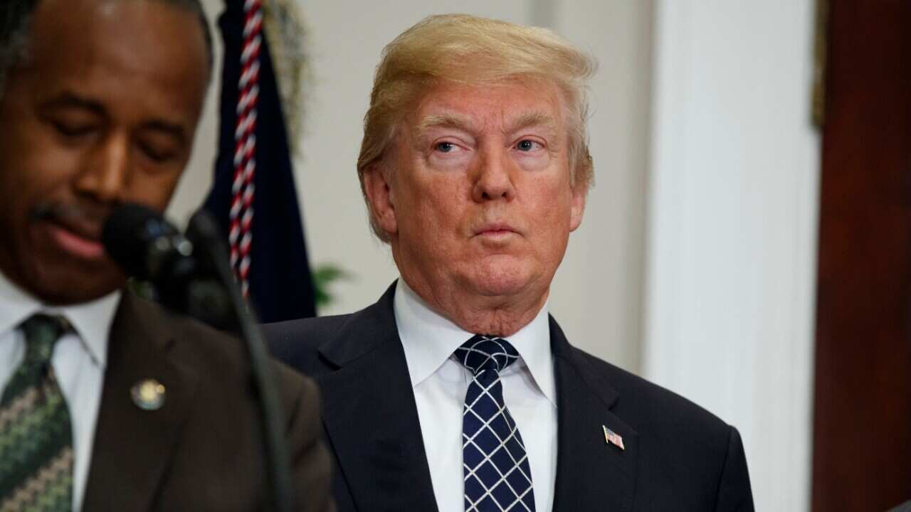 President Donald Trump listens as Secretary of Housing and Urban Development Ben Carson speaks on January 12