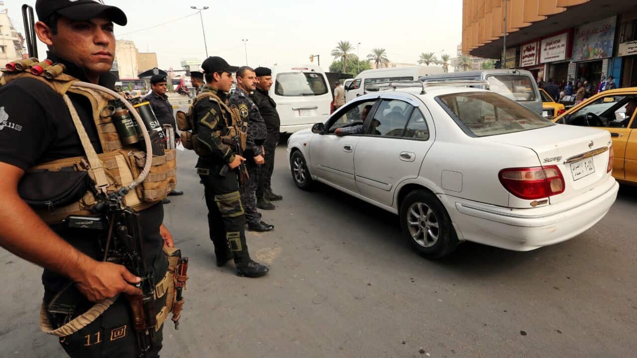 Iraqi police stand guard