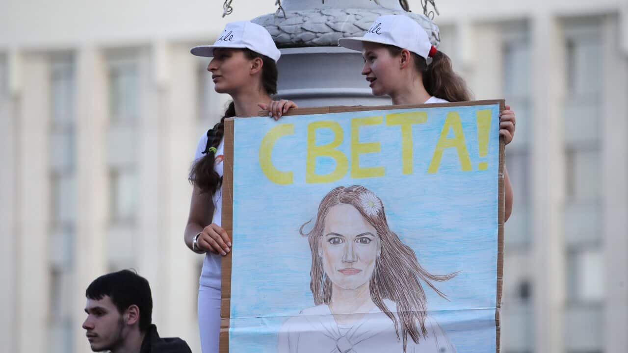 Belarus opposition activists hold a portrait of Svetlana Tikhanovskaya during a protest in front of the parliament building in Minsk, Belarus, on 17 August.