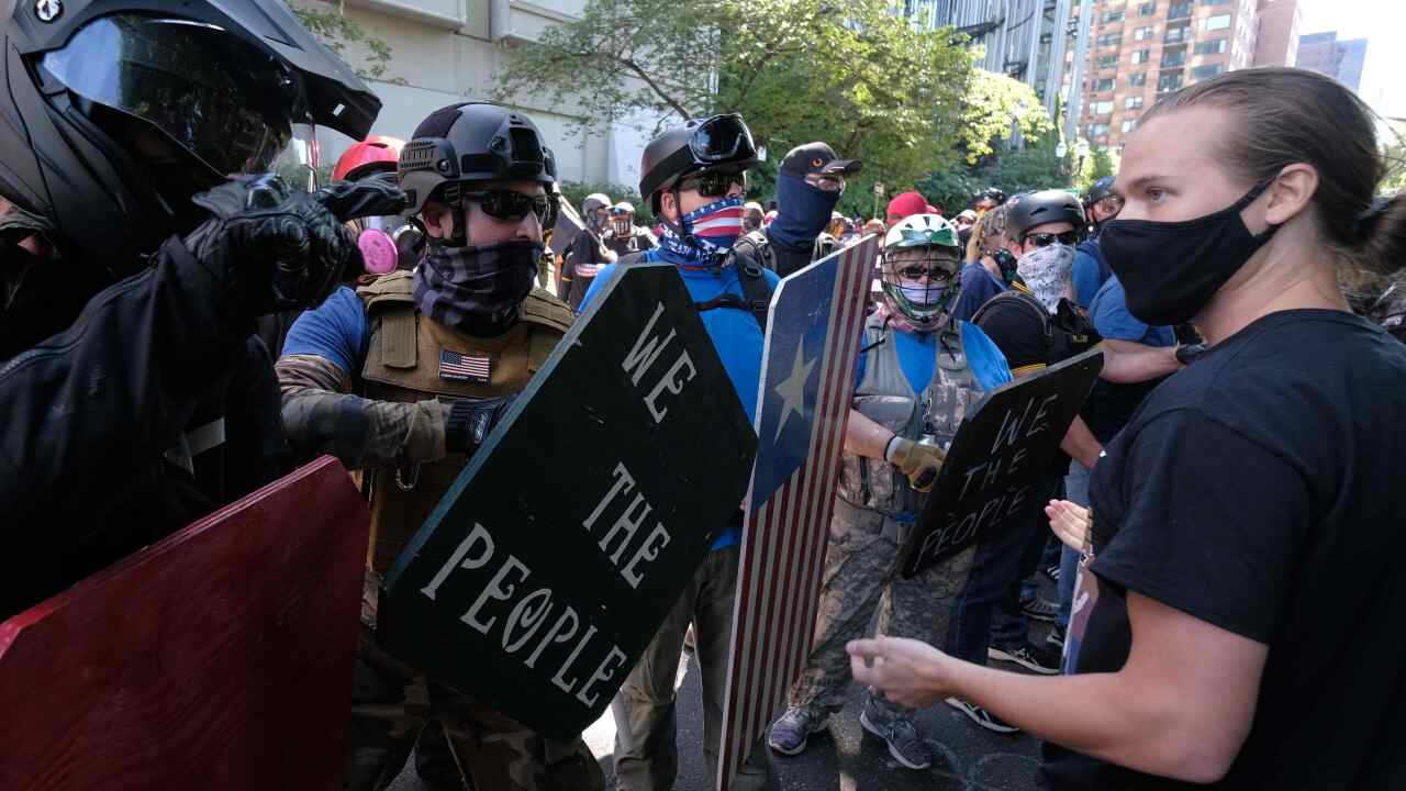 A Black Lives Matter protester confronts Trump supporters in Portland