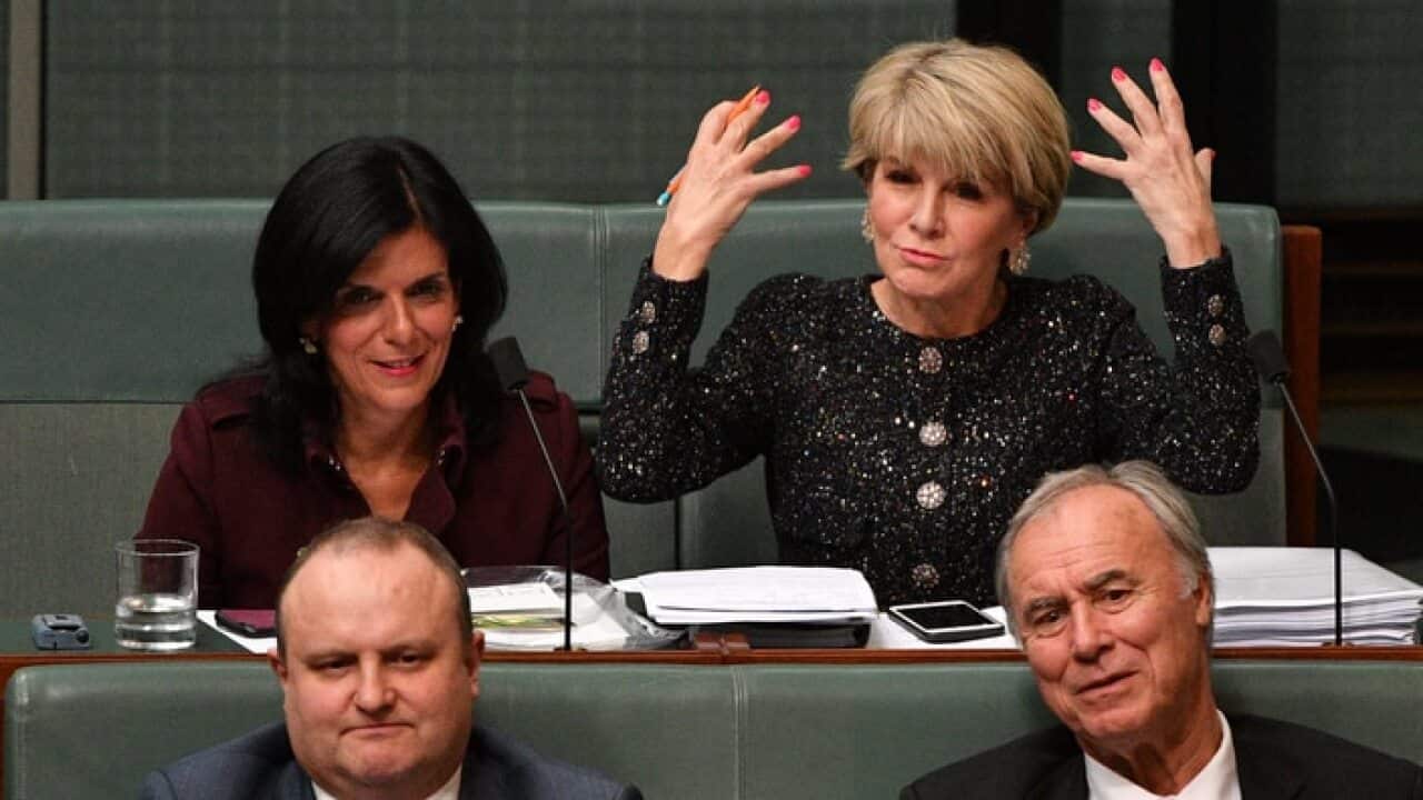 Liberals Julia Banks (L) and Julie Bishop react to a question from the opposition about Peter Dutton's eligibility during Question Time