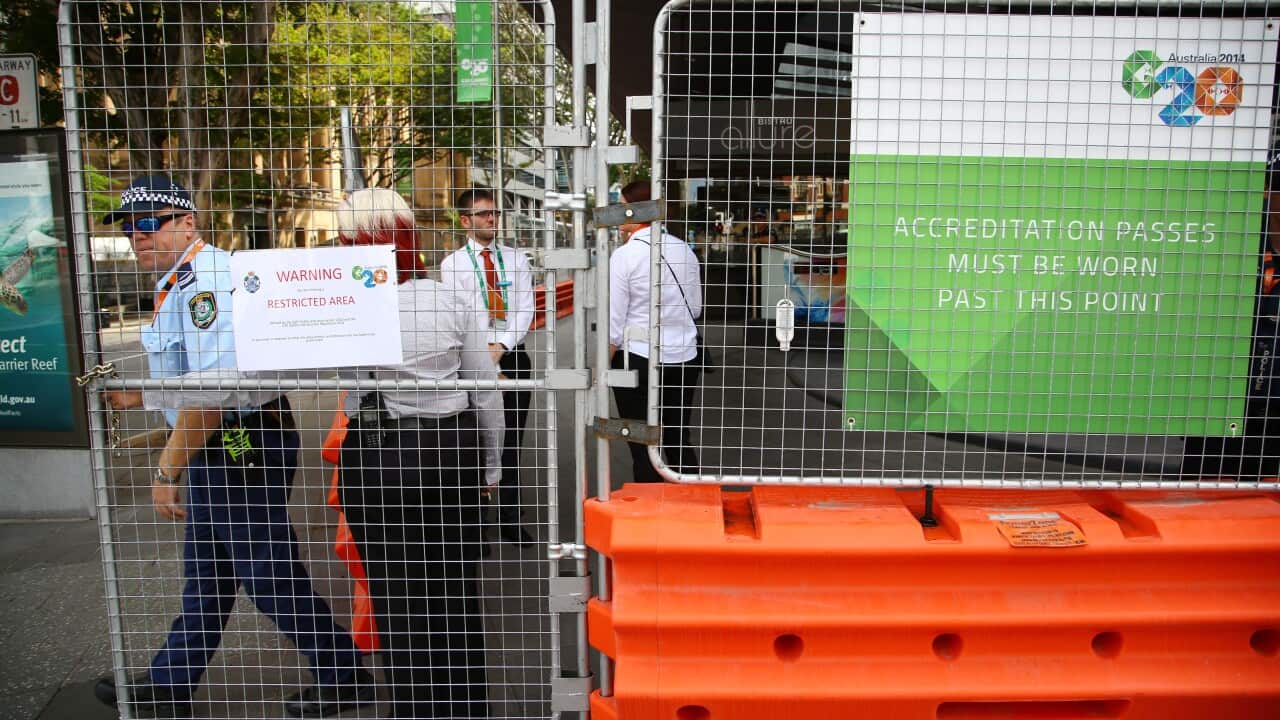 Police guard a gated entrance to an official hotel in central Brisbane ahead of the G20 conference in Brisbane (AAP)