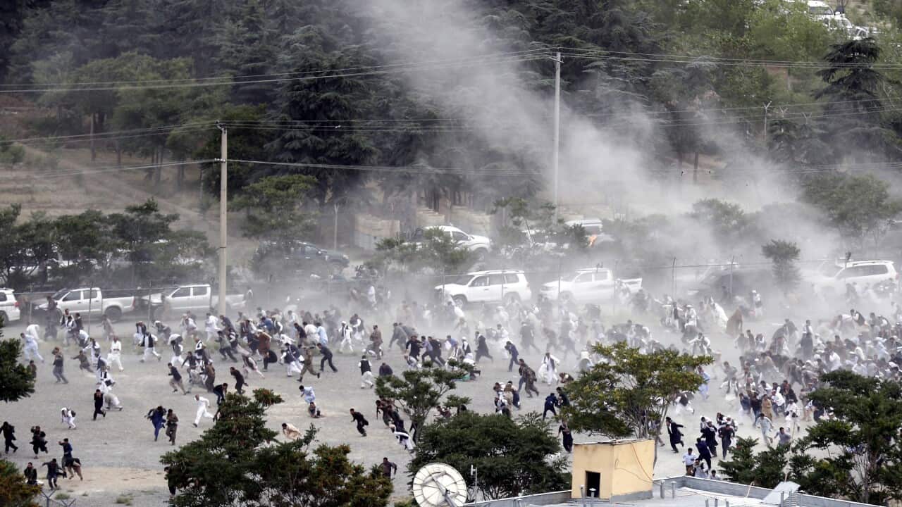 People run after an explosion during the funeral of one of the victims of Friday’s violent protests in Kabul, Afghanistan.