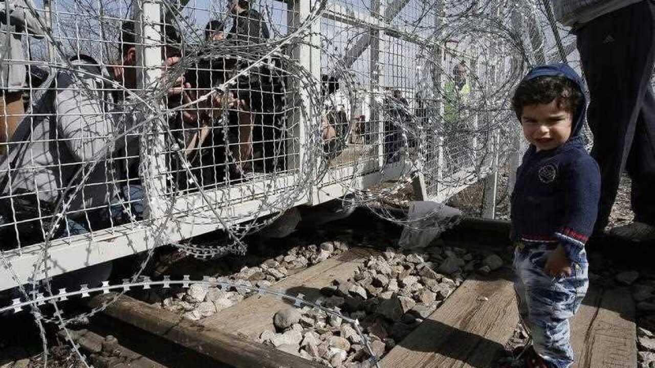 A little boy stands on the Greek side of the border fence at the Greek - The Former Yugoslav Republic Of Macedonia (FYROM) border in Idomeni, Greece,