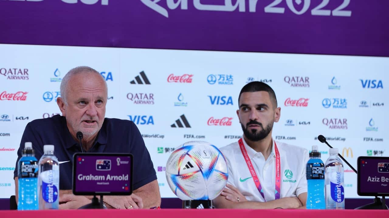Australia national team head coach Graham Arnold and player Aziz Behich (R) during a press conference in Doha.