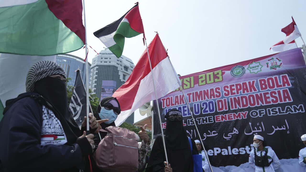People protest with flags and banners in Indonesia