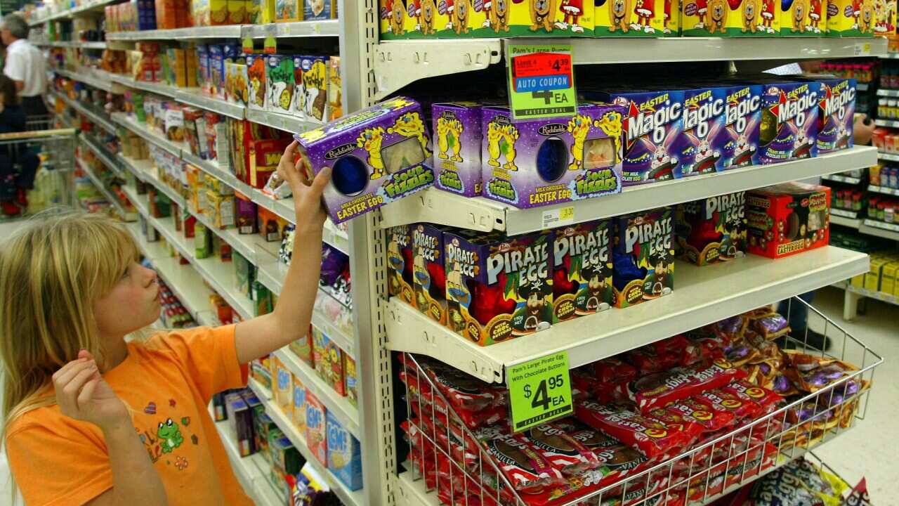 A young shopper picks out an Easter Egg from the d