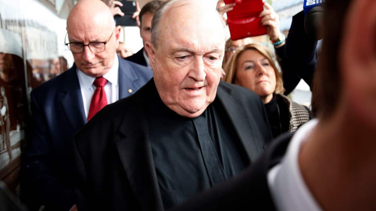 Archbishop Philip Wilson leaves Newcastle Local Court.