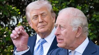 US President Donald Trump (left) and King Charles stand together in suits.