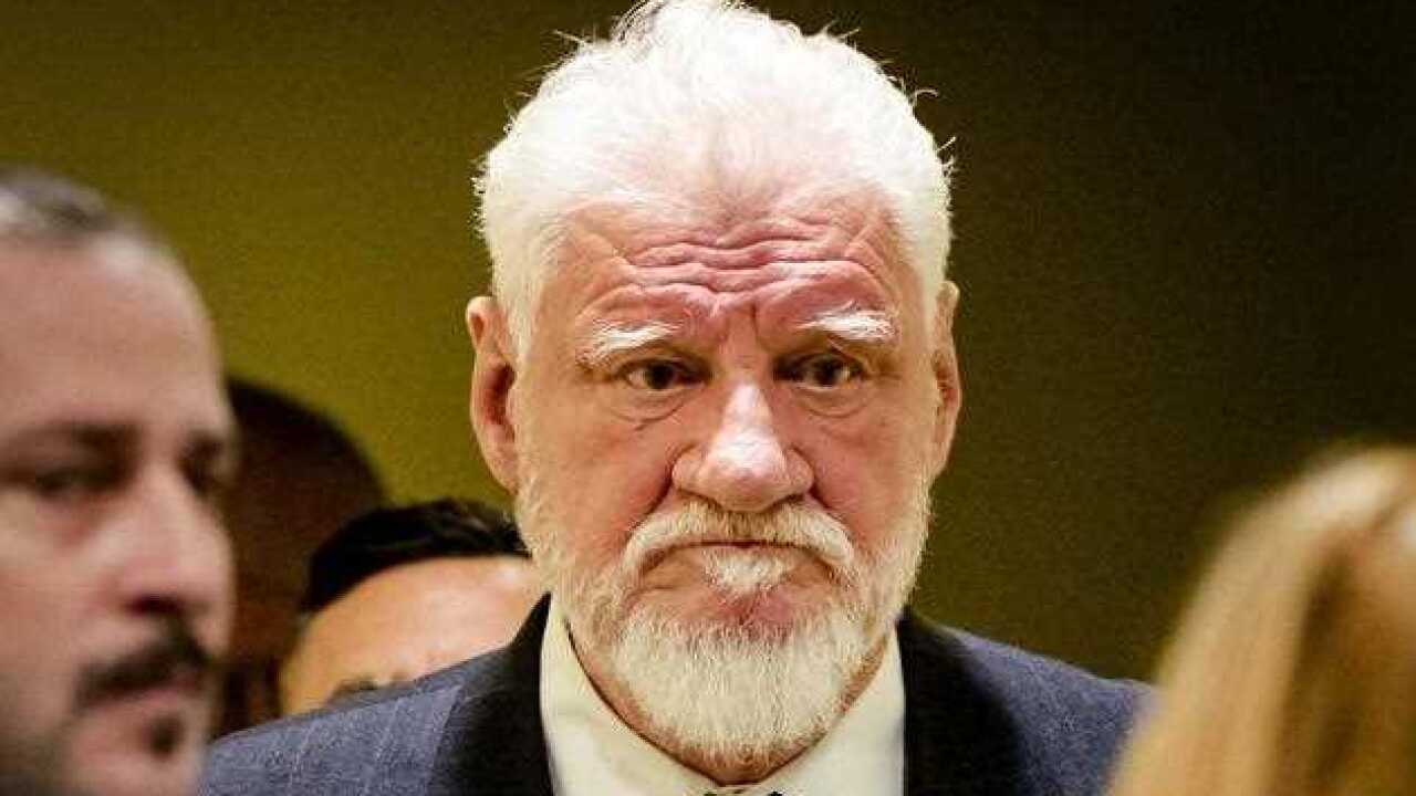 Bosnian Croat, Slobodan Praljak (C) enters the court in The Hague, The Netherlands, 29 November 2017, prior to the appeals judgement in the International Criminal Tribunal for the former Yugoslavia (ICTY), for war crimes committed.