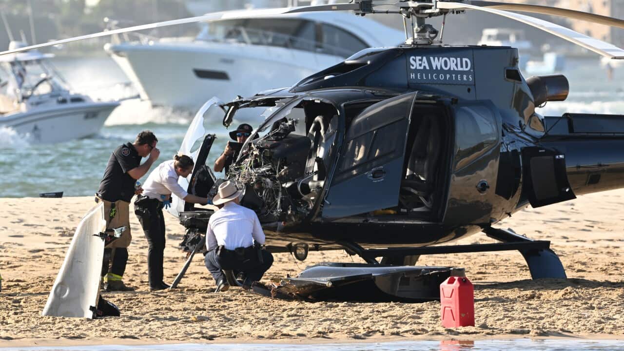 Helicopter with a damaged windscreen on the sandbank.