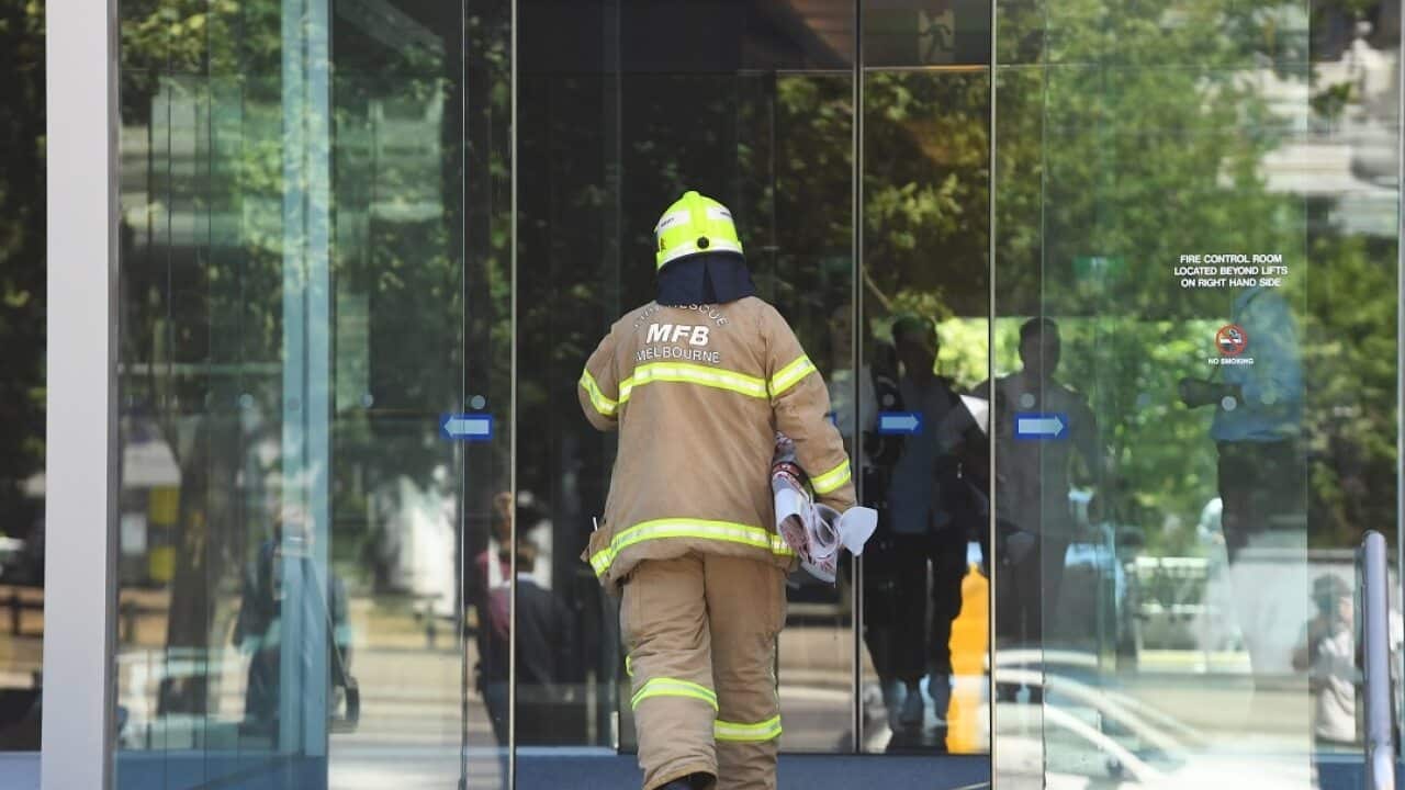 A firefighter attends to a consulate where a suspicious package was sent earlier this week.