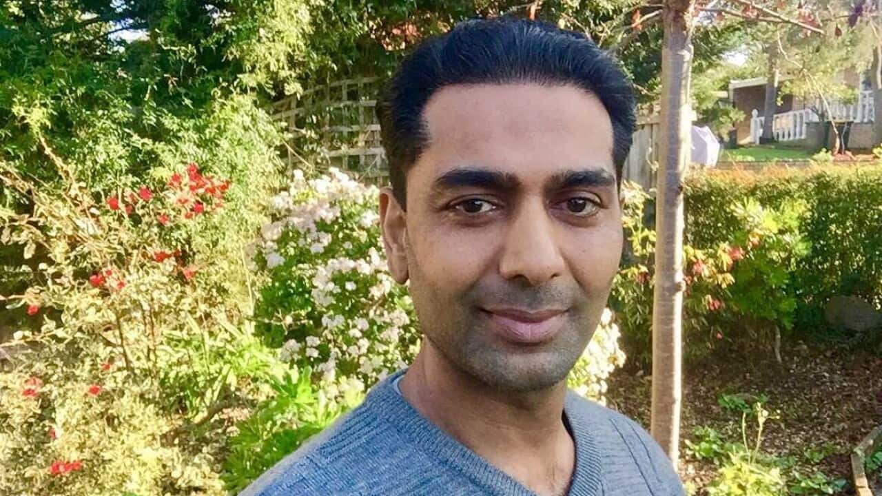 Man standing in a garden looking at camera