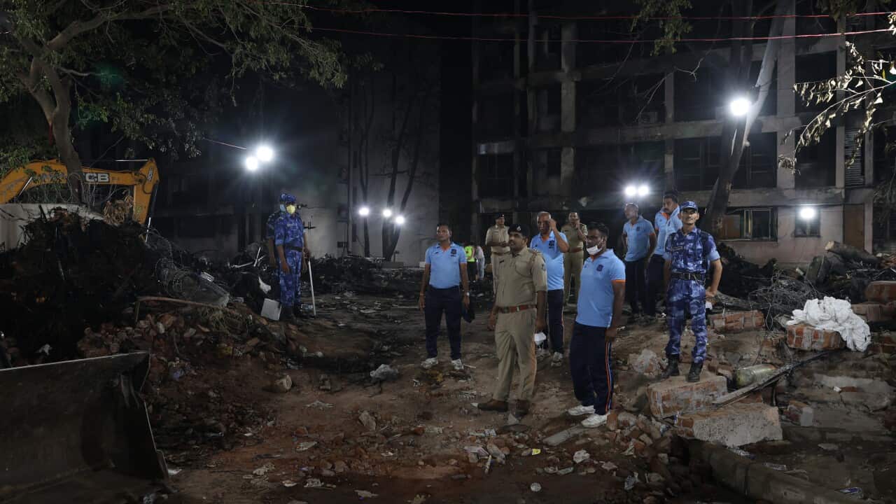 Officials inspect the site of a plane crash.
