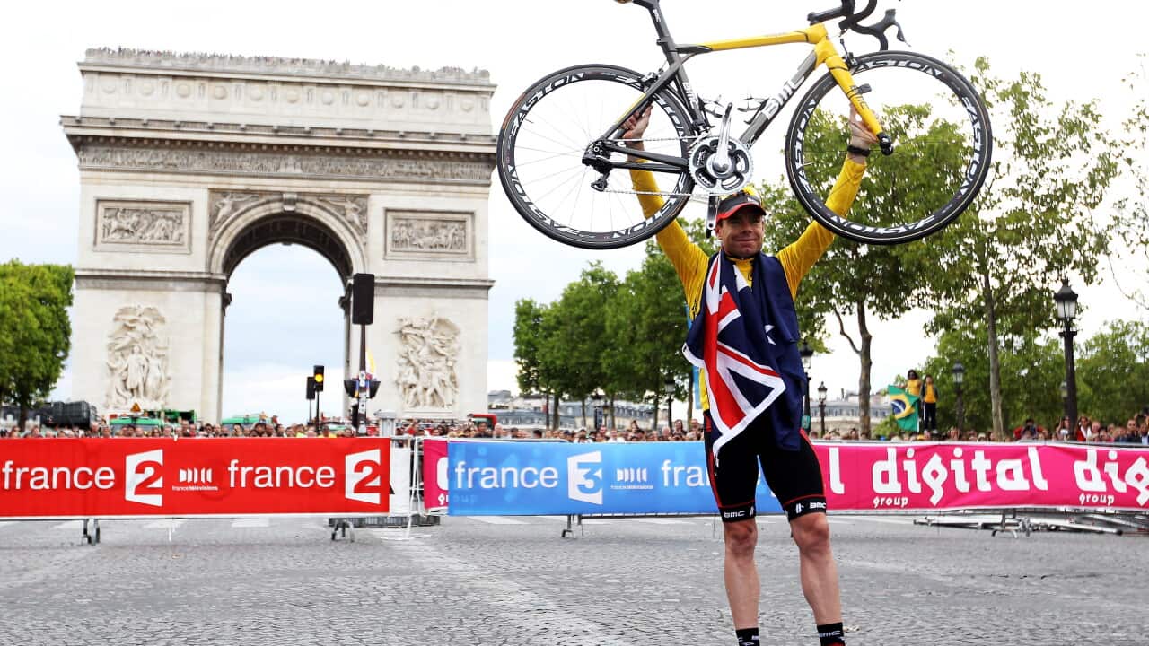 cadel_evans_of_team_bmc_poses_for_photos_as_he_takes_part_in_a_victory_parade_after_winning_the_2011_tour_de_france_getty_images.jpg