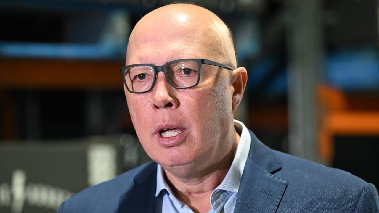 Peter Dutton in a suit and wearing glasses