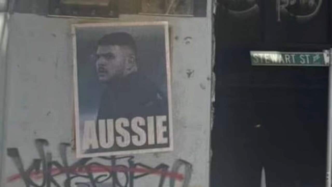 A poster with an image of alleged Bondi gunman Naveed Akram and the word "AUSSIE" written underneath it.