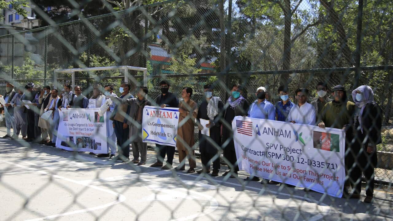 Former workers who had been employed with U.S. troops at the Bagram airbase hold placards during a demonstration against the U.S. government in Kabul, Afghanistan, Friday, July, 9, 2021. (AP Photo/Mariam Zuhaib)