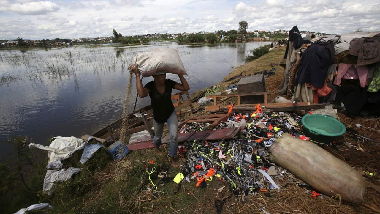 A man carries belongings from his house destroyed by tropical storm Ana in Antananarivo, Madagascar
