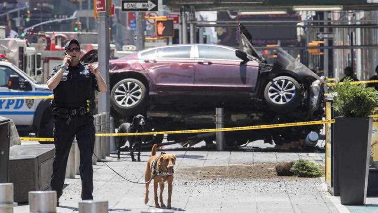 Investigators works at the scene of a car crash, Thursday, May 18, 2017, in New York's Times Square.